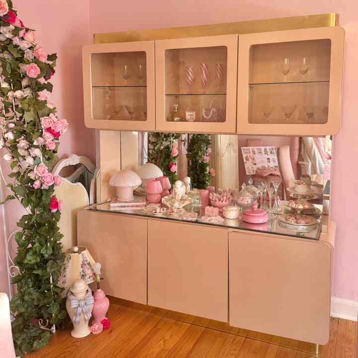 One of the coolest pieces of furniture I think I own… this super rad lacquered hutch is so space age barbie. #pink #pinkinterior #diningroom #hutch #vintageinterior 