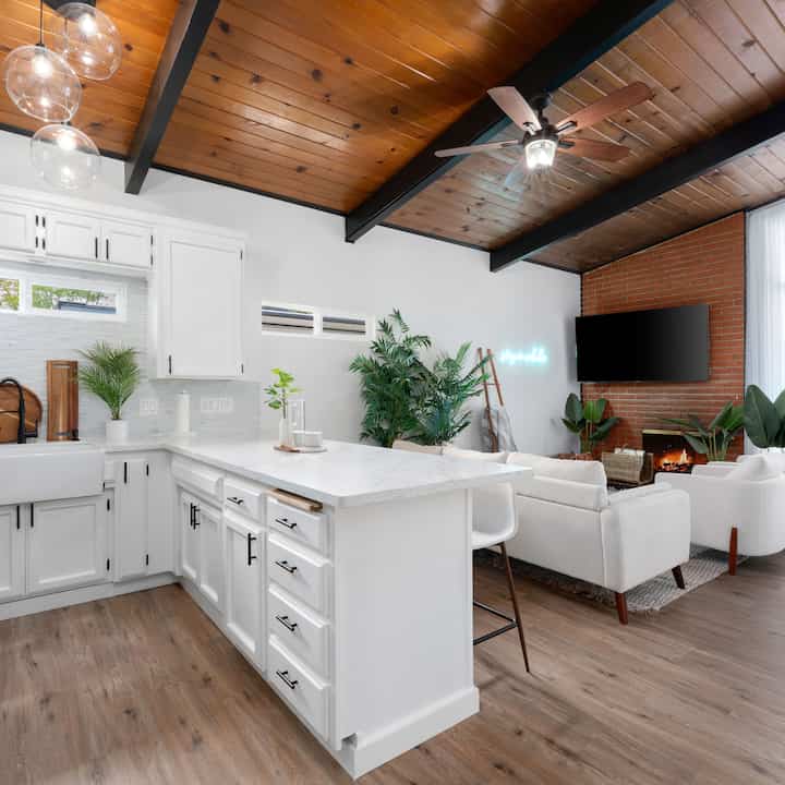 Modern white kitchen and living room with plant accents #greenery 