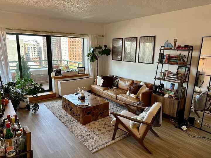 Warm brown and wood tone living room featuring leather sofa and wooden coffee table, showcasing a natural modern style space
