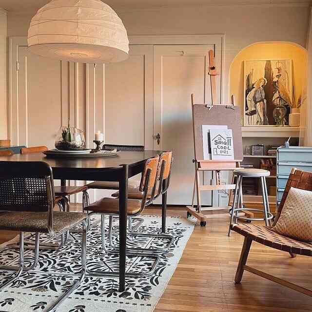 Mid-Century Modern dining room and home office space featuring brown wood tones and black furniture with vintage accents