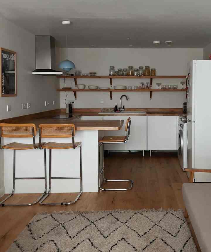 Cozy vibes and stylish design in my white wooden kitchen! 🍽️✨ Loving every moment spent here. Credit: @bintabuheh #HomeSweetHome #KitchenGoals