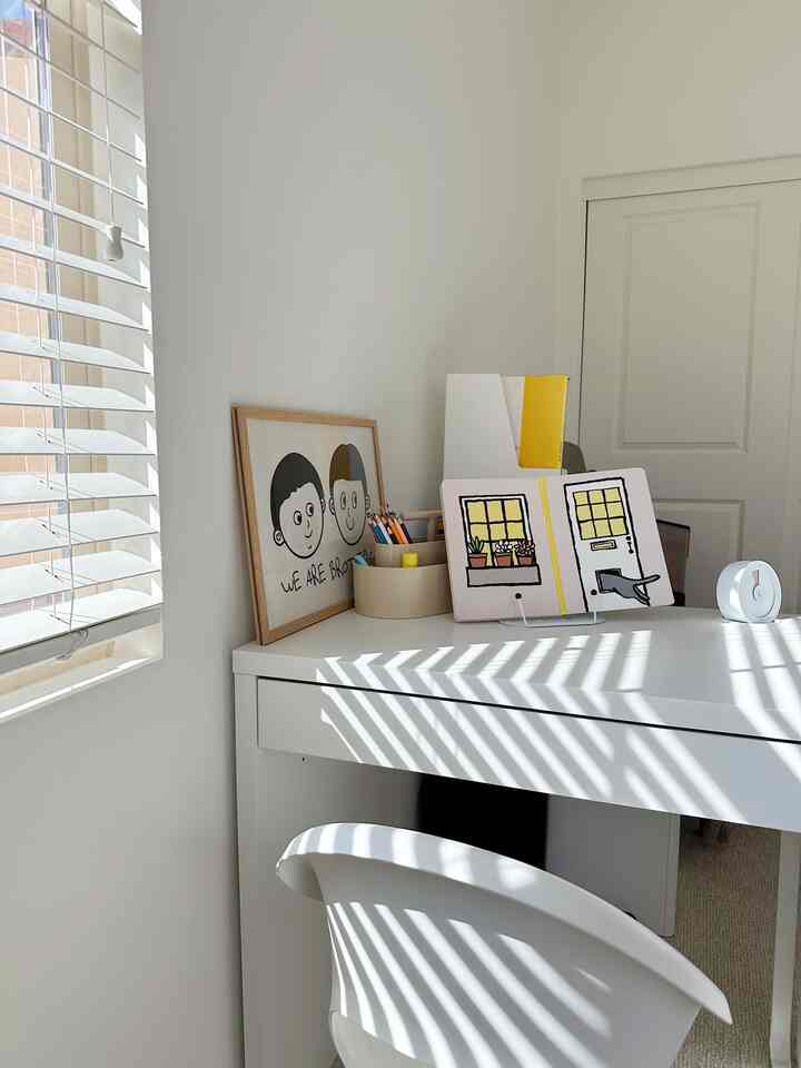 Bright and natural-toned home office featuring a white desk and chair with a clean and cozy atmosphere