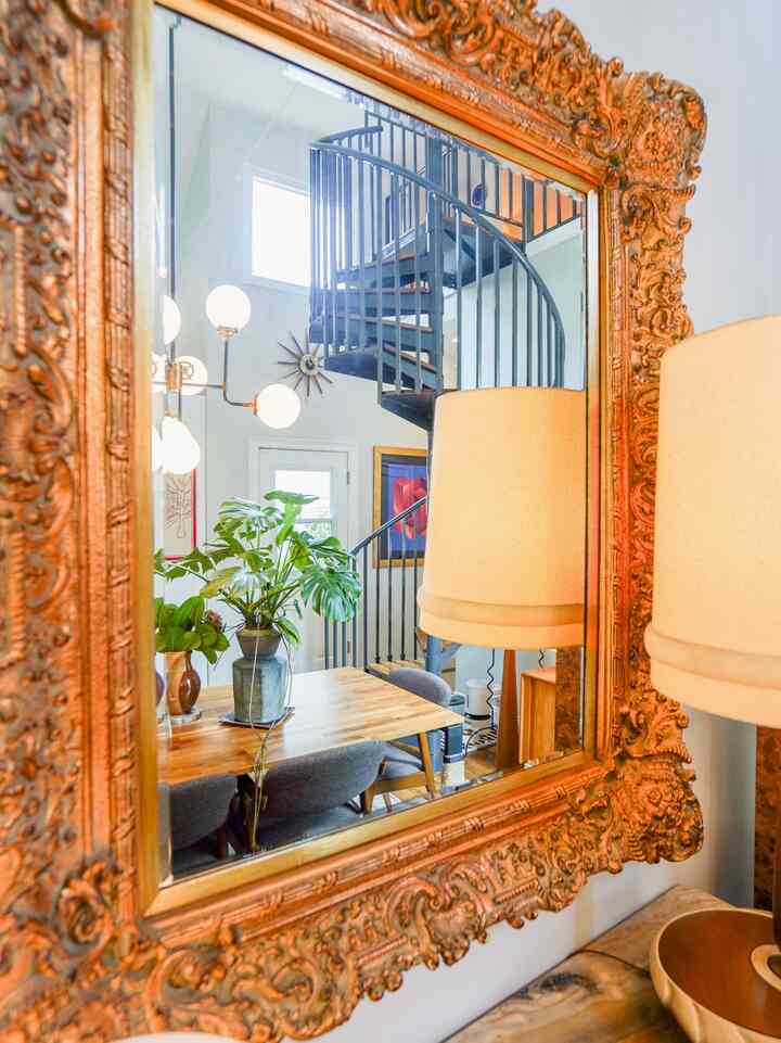 Antique mirror styled in my dining room - I love how it reflects all of my lamps/lighting during the evenings #eclectic #transitional