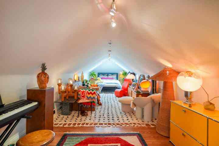 My favorite room - the bedroom! It’s long and narrow with unique slanted ceilings. I’m able to fit so much in here! And the cats love all of the extra fun seating in here too #postmodern #eclectic #colorful