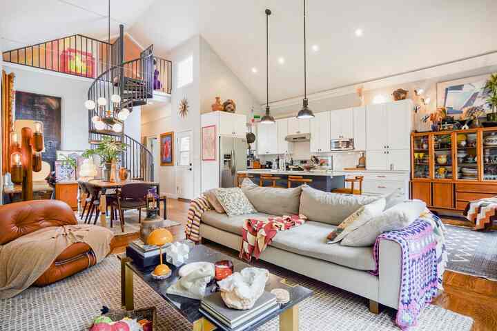 White and brown toned living room and kitchen featuring mid-century modern vintage style elements