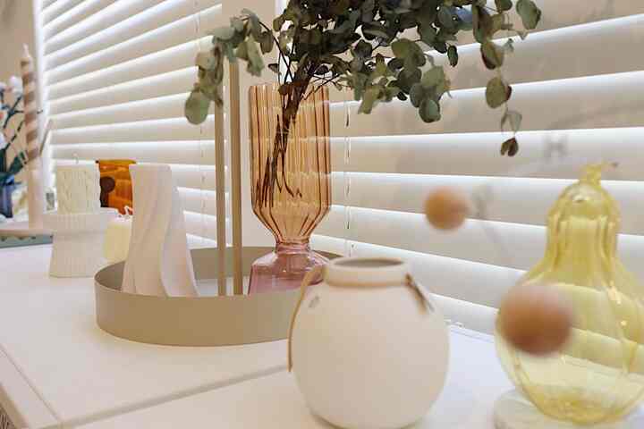 Mid-Century Modern style space featuring a white-toned table with various decorative objects and a tray