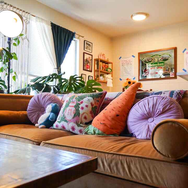 I love the warmth of my living room— it makes it inviting for my guests! #maximalist #mustardcouch #plants