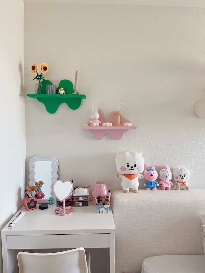 White and natural tone compact single household vanity desk corner featuring plush toys and whimsical shelves with cozy atmosphere