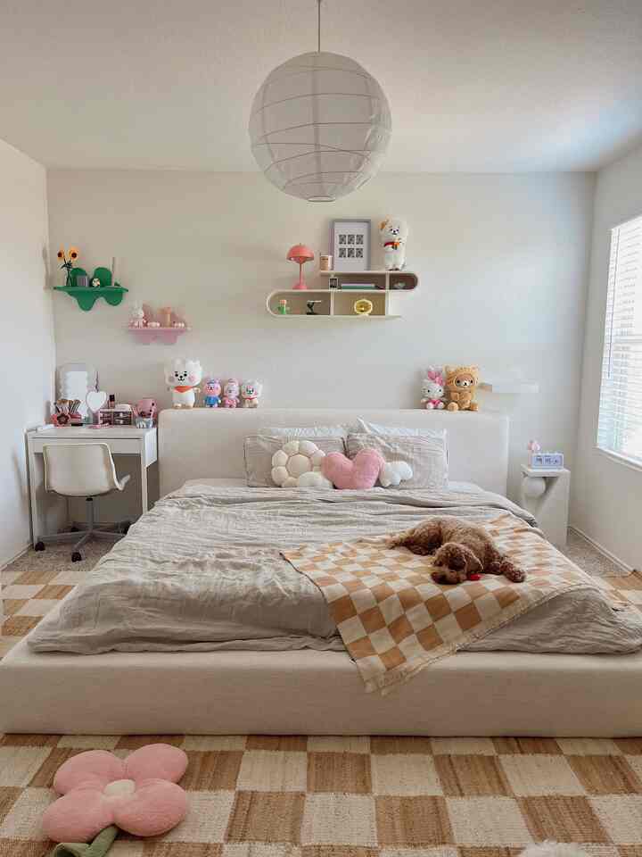 Beige-toned bedroom featuring a low bed centered with wall shelves and a pendant light creating a cozy atmosphere