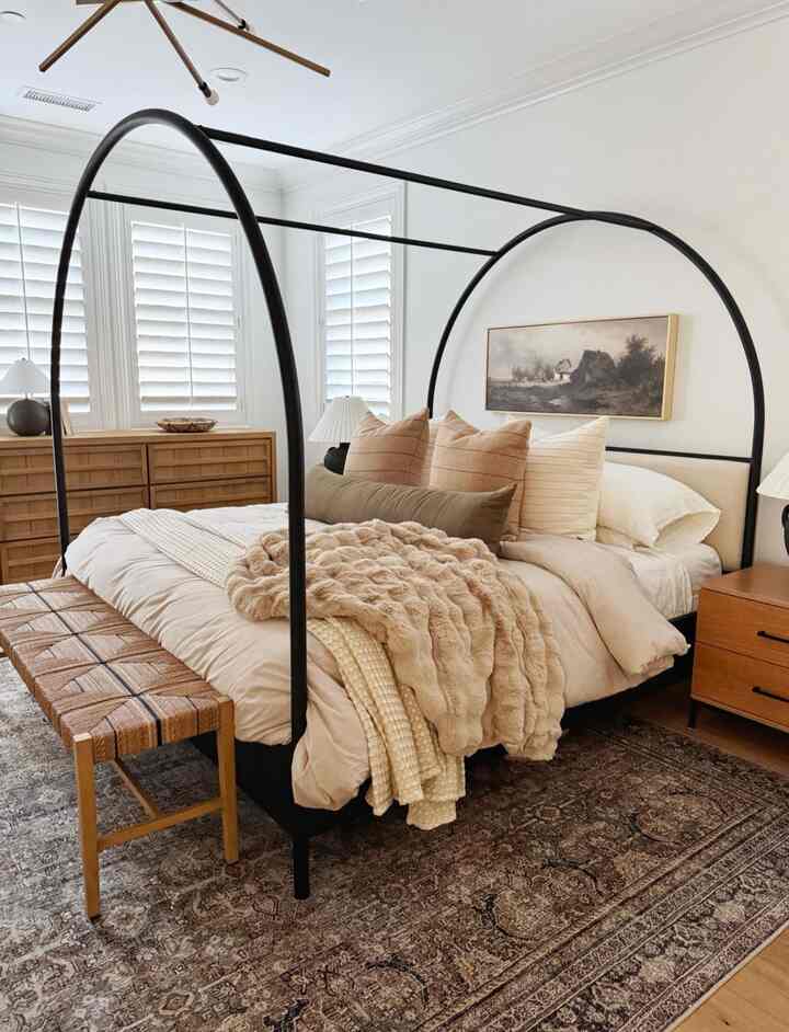 White and brown toned bedroom featuring a Canyon Queen arched canopy bed and natural wood furniture, creating a cozy atmosphere
