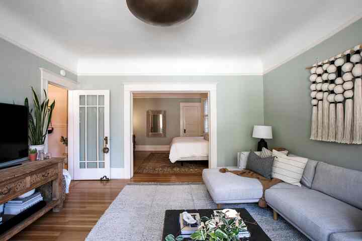A seamless transition from living room to bedroom in this ecelectic San Francisco apartment. The great thing about these set ups is you can eaisly close the sliding doors when you need the privacy and open for a more open feeling during daily use! #sanfranciscoapartment #livingroominterior #livingroom #openfloorplan #bedroom #eclectic #curated #stylinghome #styling 