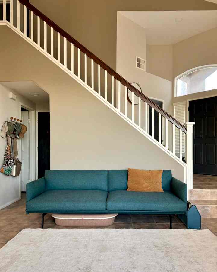 Beige-toned living room featuring a green sofa with a warm and cozy atmosphere