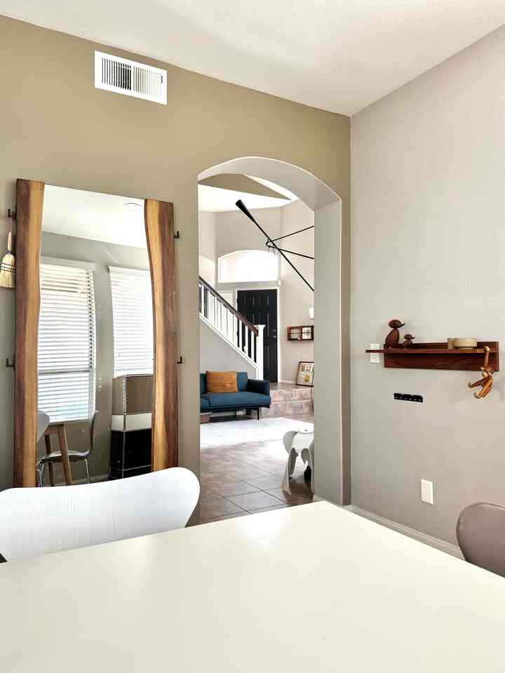 Beige and wood tone dining room view into living room and entrance with cozy atmosphere