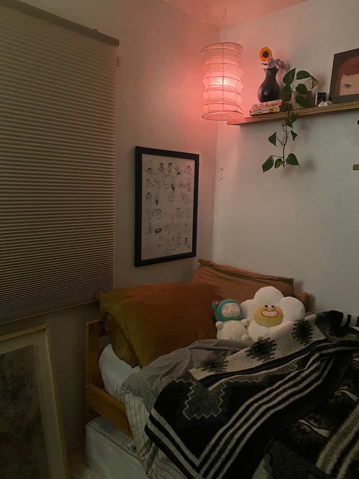 Warm brown natural-toned bedroom with moodlight and picture frame creating a cozy atmosphere