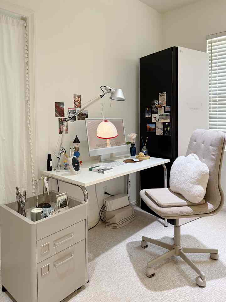 White and beige toned Mid-Century Modern home office space featuring sleek desk and office chair with a minimalist, cozy atmosphere