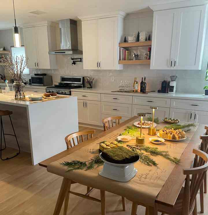 Bright white and wood tones blend in a natural Japandi style dining room featuring a wooden dining table and chairs with a warm, cozy atmosphere