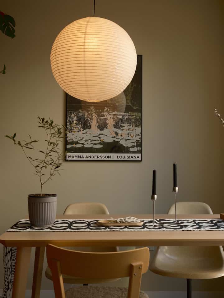 Natural wood tones and white lighting in dining room featuring Mid-Century Modern dining table and chairs