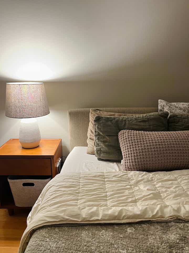 My favorite bedroom hack is to attach wire organizers to the side of my nightstand, so they’re easy to access when you’re going to sleep 😴 #bedroom #thuma #natural #earthytones #naturalinterior #cozy #neutral