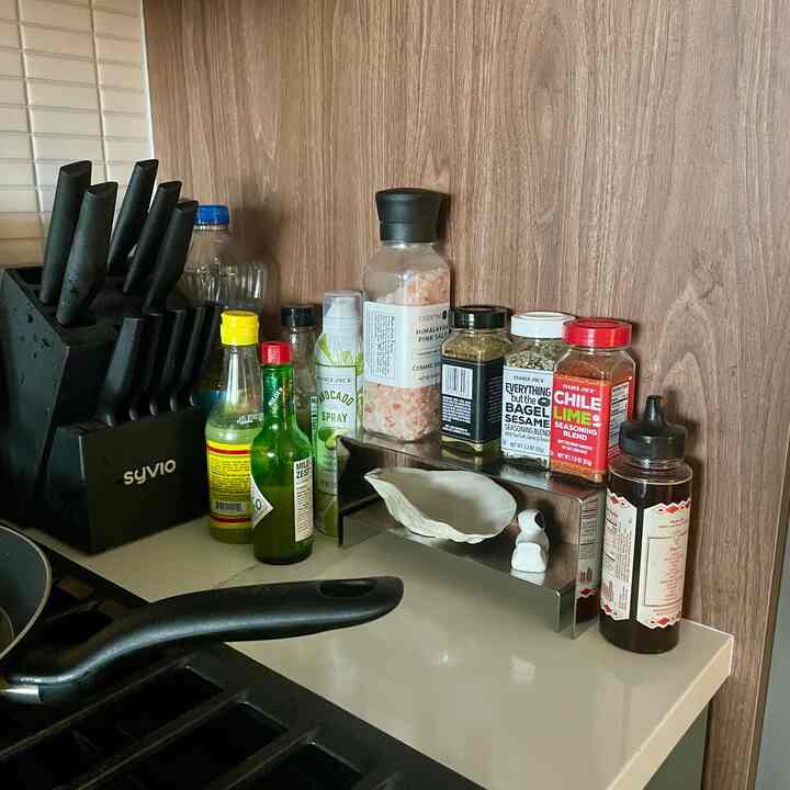 Love repurposing different things for organization. I used these handbag riser stands as an alternative to a spice rack! #spicerack #kitchencounter #repurposed