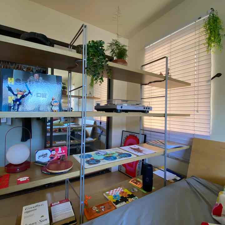 Beige and natural-toned small home office space featuring a long shelf with an Audio-Technica turntable and accessories, clean remote work setup