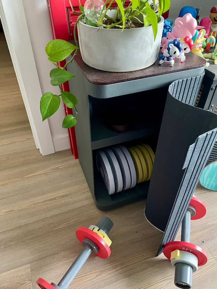 Love this hidden weight rack in my living room. Perfect for quick at home workouts. #weightrack #workout #barbells 