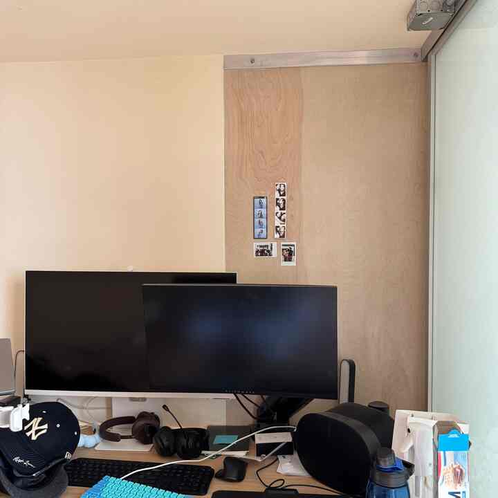 Beige and wood tone compact home office featuring dual monitors and office furniture with a practical atmosphere