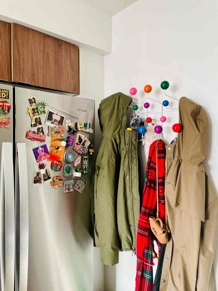 My current place has a small entryway, so adding the Eames Hang-It-All was perfect! I use it for quick drop offs of our items and love how it compliments the colors of our fridge magnets #color #personality #entryway #smallspaces #kitchen
