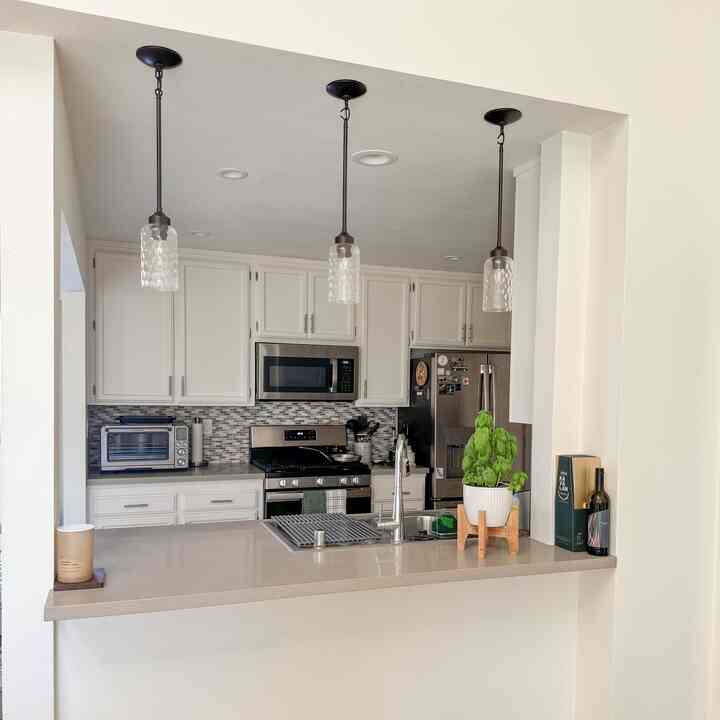 kitchen view from my livingroom 

#kitchen #livingroom #whitecabinet #smartoven #airfryer #stainlesssteelpan #planter 