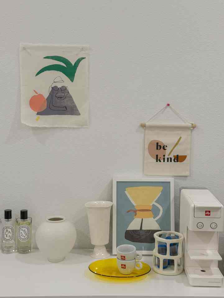 White and natural toned home cafe space featuring coffee machine and cups with a clean interior