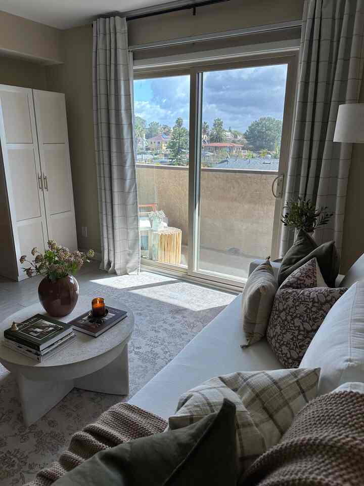 White and brown toned living room featuring coffee table and cushions with cozy atmosphere