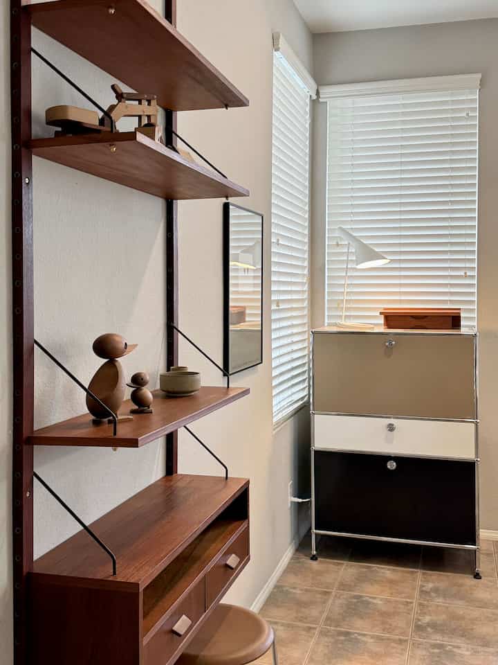 Natural small entrance room featuring wood tone wall shelves and a modern multi-functional storage cabinet