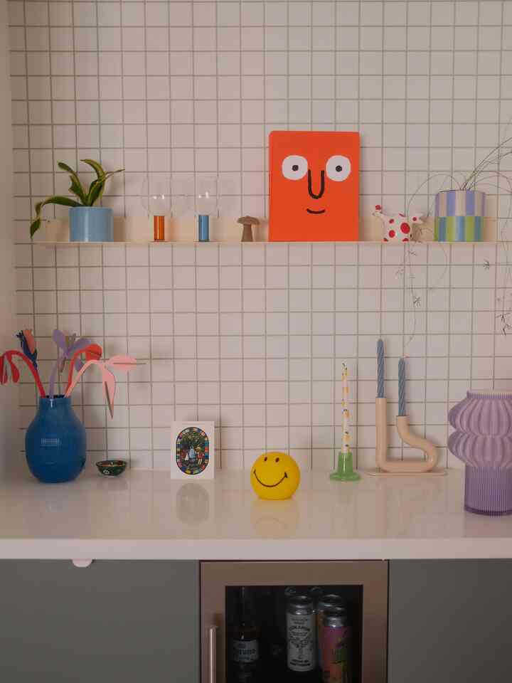 Pastel-tone kitchen space featuring various blue vases and playful decorative items creating a cheerful ambiance