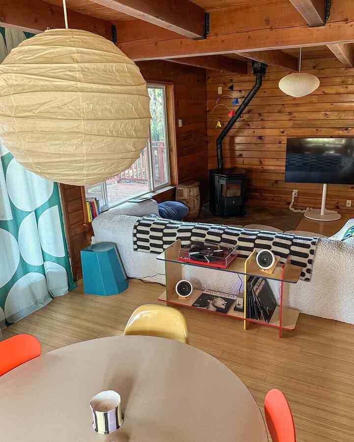 Natural wood-tone living room featuring a sofa, fireplace, and warm atmosphere