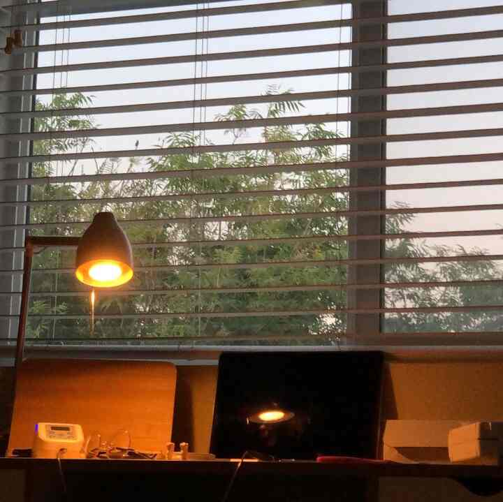 Natural tone 6-tatami home office featuring wood desk and chair, warm table lamp lighting creating quiet ambiance