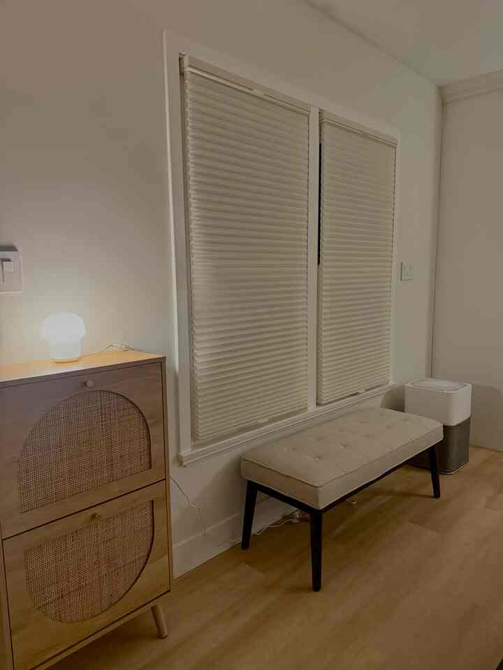 Ivory and natural wood tone entrance featuring a bench and shoe cabinet with a warm Japandi style atmosphere