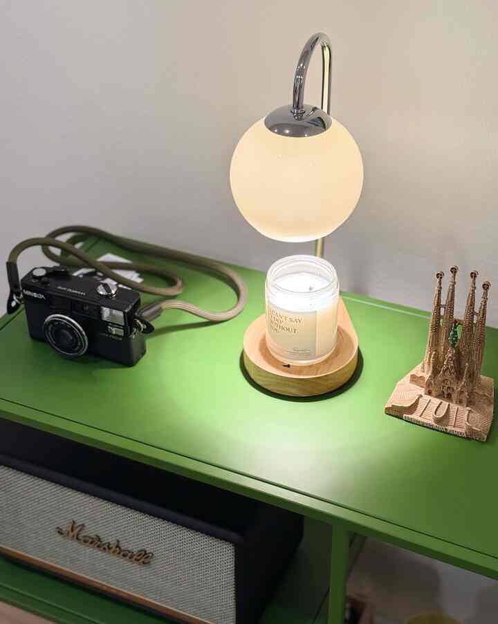 Modern interior featuring a natural color side table with a table lamp and decorative accessories