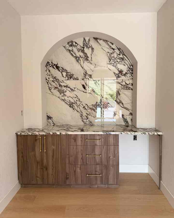 Before & After

We’re almost finished.
Originally, this was a tiny room on the first floor that held just a wine cabinet.
By removing the walls, we opened up the space and created a cozy little bar.
We installed built-in cabinets and made what I truly wanted a reality with a porcelain slab arch for the bar.
Every detail mattered, even the cabinet pulls, bringing a refined touch to the space.

The door on the other side opens up to the pool, and I can’t wait for this summer! 💛

#remodeling #barinterior #pocelineslab #builtincabinet #pulls