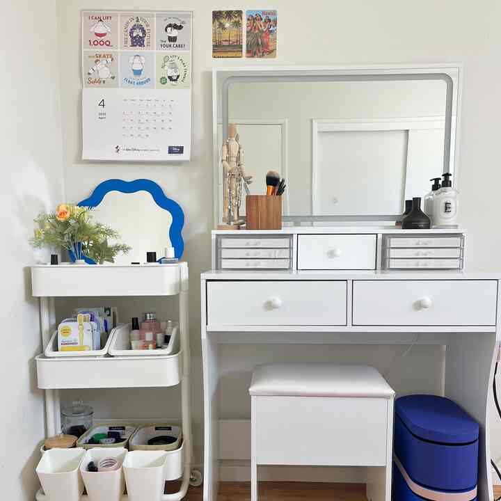 White-toned bedroom corner featuring a vanity and corner storage with a simple, clean design