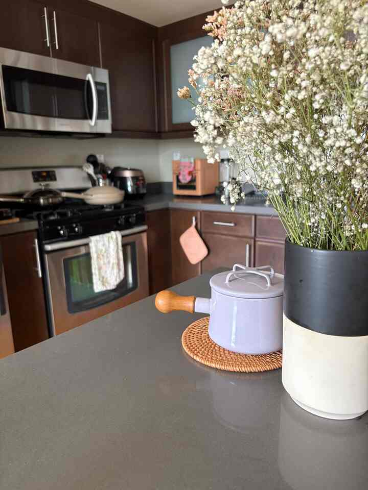 My cutie Dansk Butter Warmer peeping out behind my flowers! I love putting dried flowers in my vase so that I don’t have to replace them as often 🌼 #dansk #kitchen #walnutinterior #darkwoodkitchen 