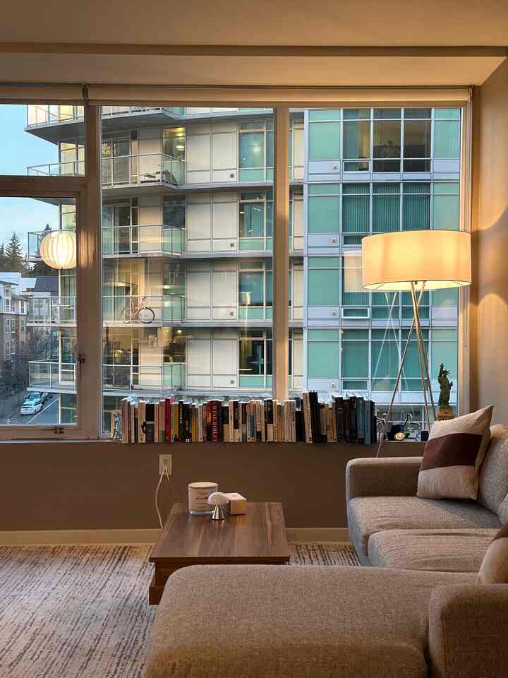Warm beige and wood-tone living room featuring a large sectional sofa and wooden coffee table with cozy ambiance
