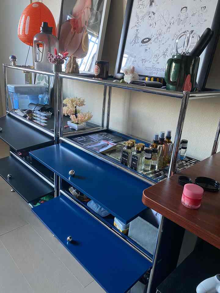 Minimal style space featuring blue and black shelving and storage units with a tidy and organized atmosphere