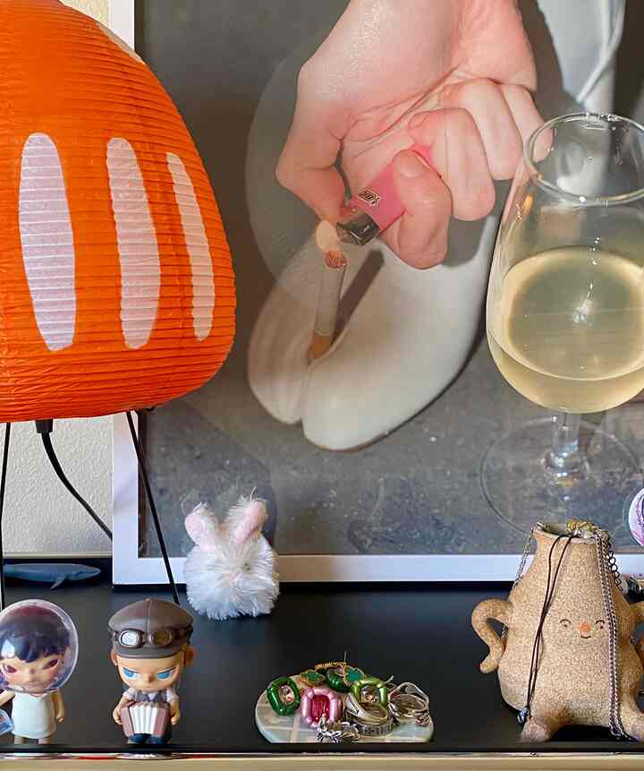 Orange table lamp and assorted objets in a cozy Japandi-style table setting