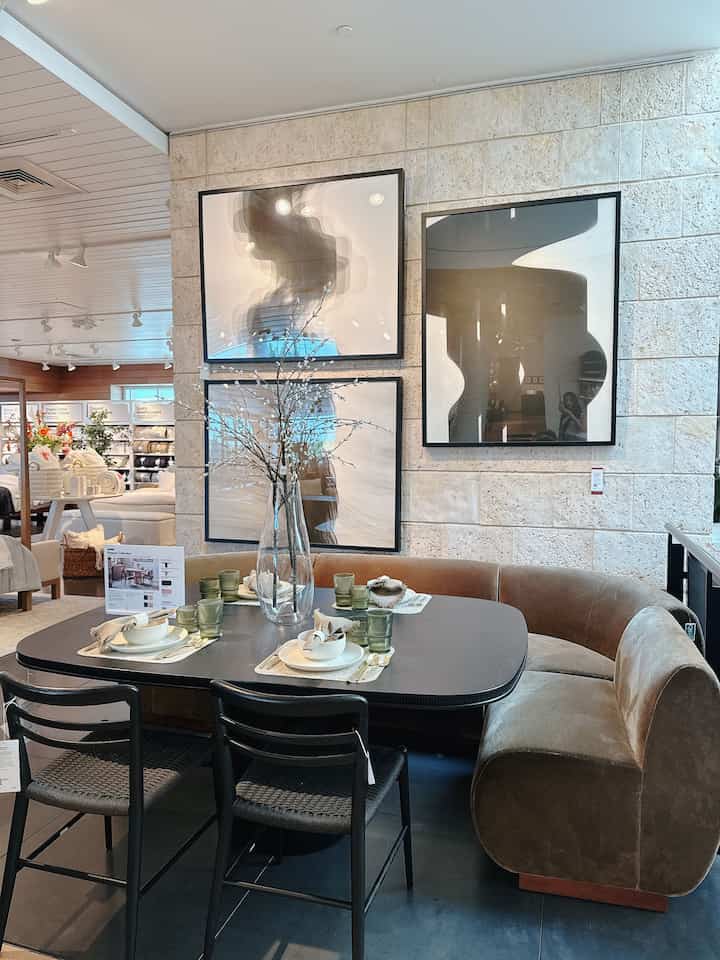 Modern dining room featuring olive green velvet sectional sofa corner and black dining table with chairs