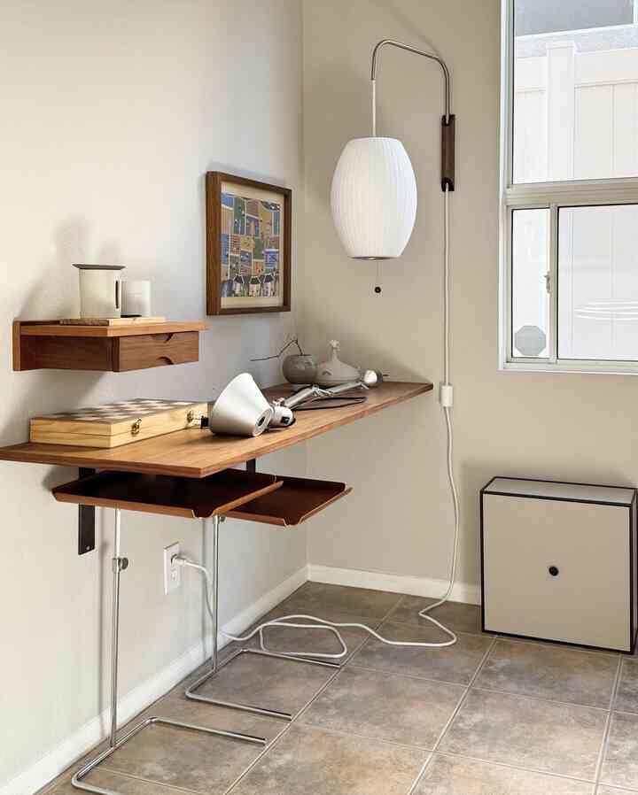 Natural beige tone room with small wood desk and wall sconce lighting, creating a cozy atmosphere