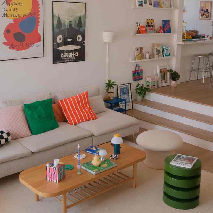 A beige and wood-toned living room featuring a comfortable sofa and coffee table in a simple, natural setting