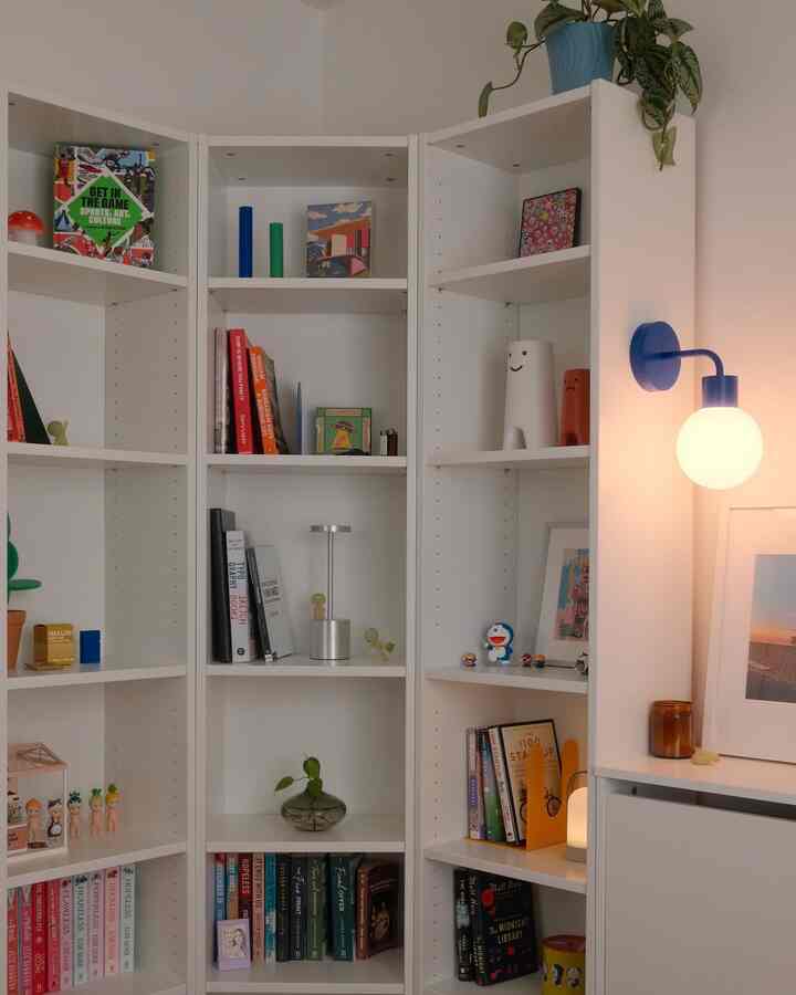 White tone corner bookshelf in a cozy home office space