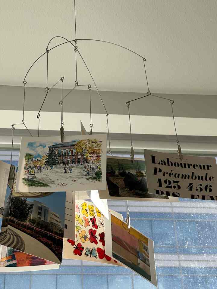One things I love to add color in my apartment is to hand cards or photos on a clip mobile. Then I attach it to a thumbtack hanger on the ceiling! Love the view looking up from the dining table full of flowers.

#mobile #photos #livingroom