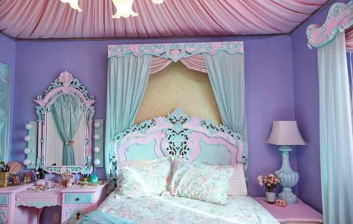 A bedroom featuring a harmonious pink and mint color scheme, floral bedding, and ornate classic decorations creating an elegant space