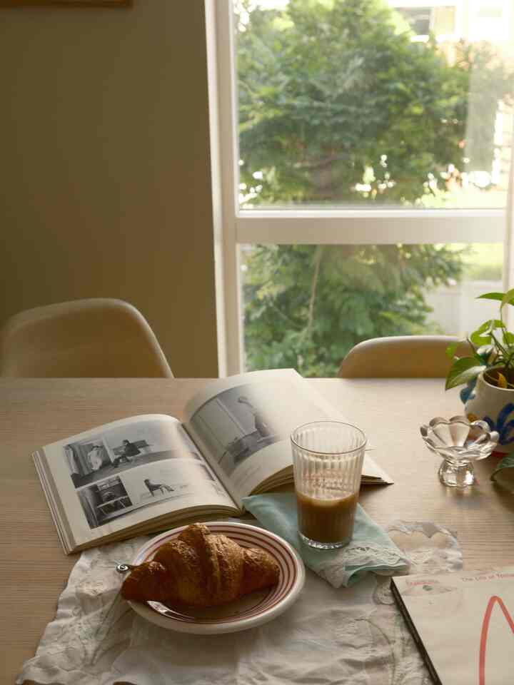 Natural-toned dining room featuring a wooden table by the window with home cafe elements creating a cozy atmosphere
