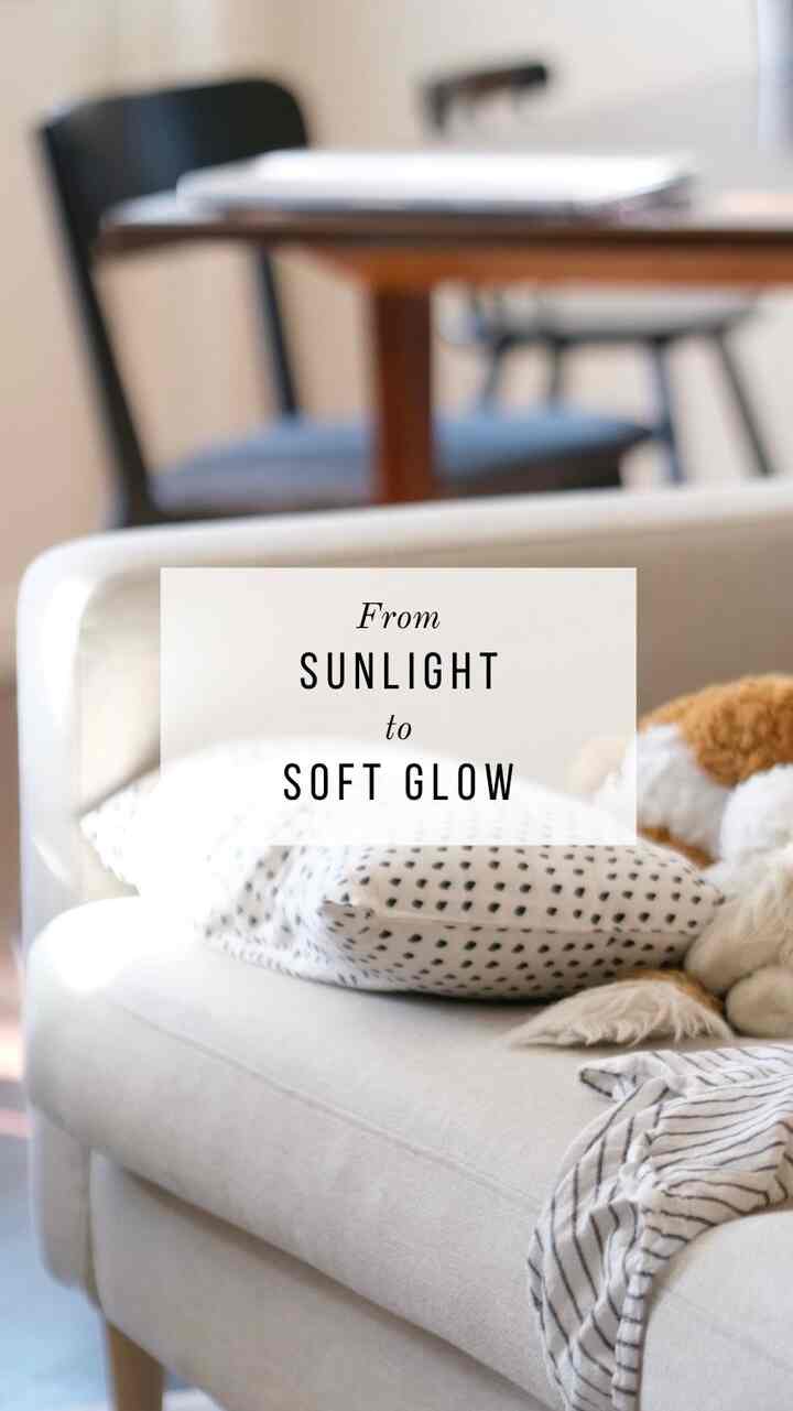 Bright beige sofa and wood tone furniture in a modern living room and entrance space with a cozy atmosphere